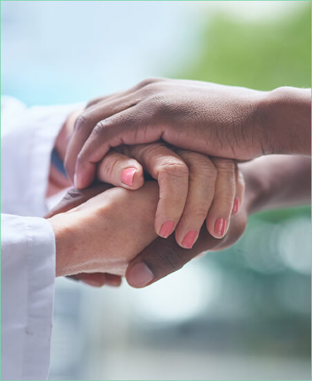 close up of doctor holding patient's hand